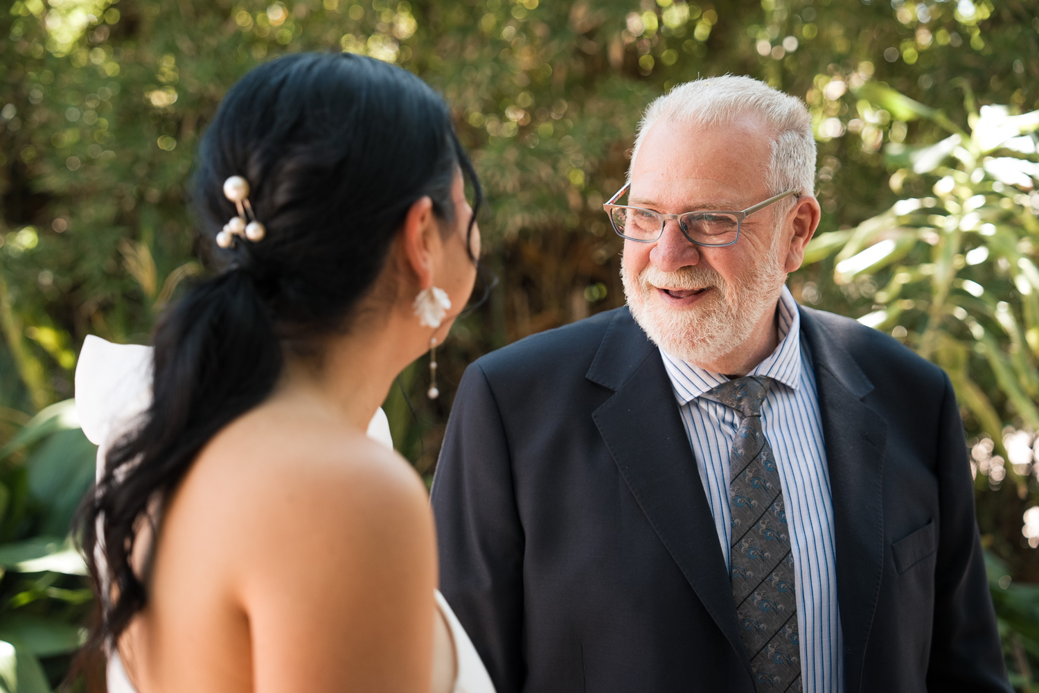 padre sonríe a su hija en boda